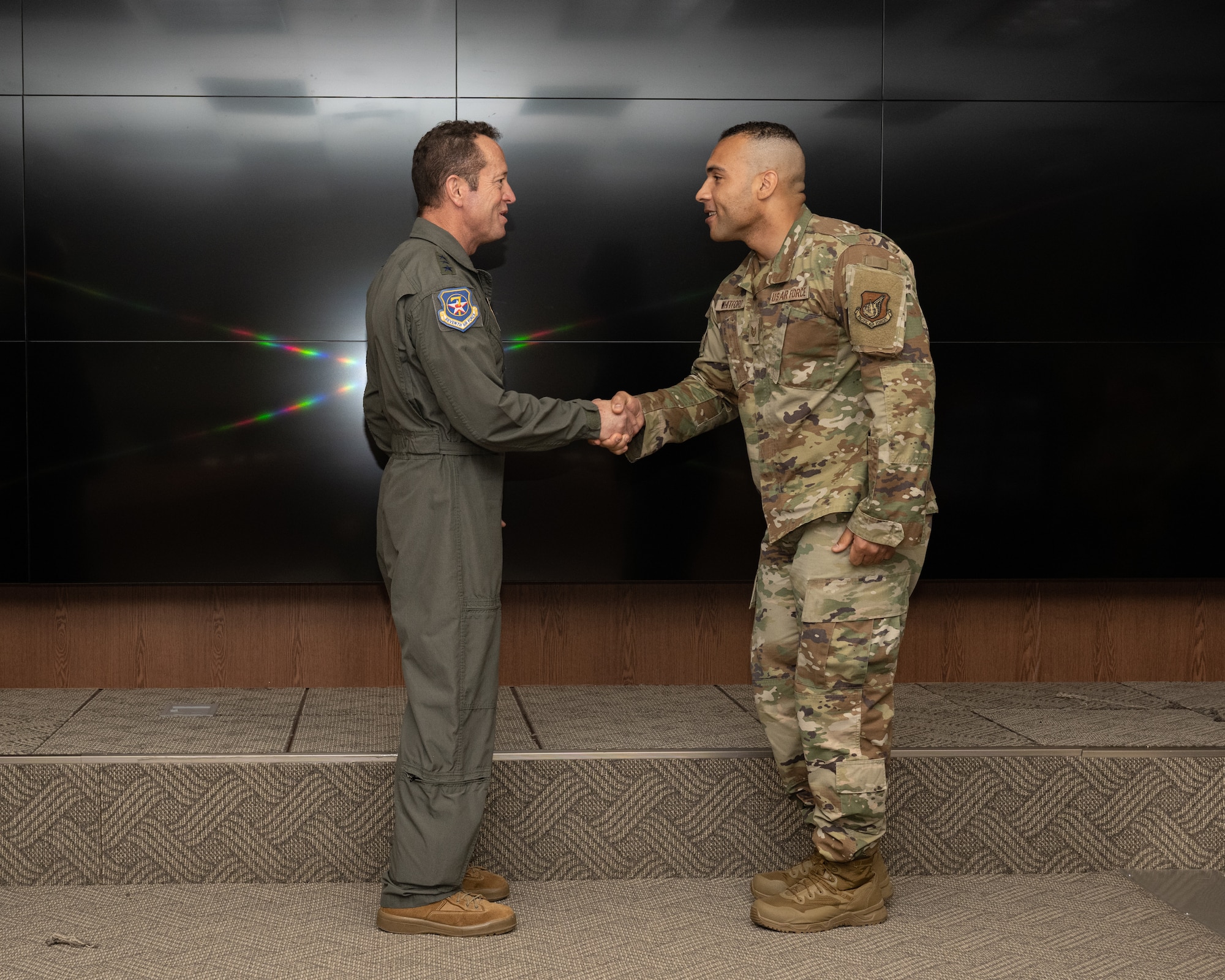 Lt. Gen. David Iverson, left, 7th Air Force commander, coins Tech. Sgt. Joshua Whitford, 80th Fighter Generation Squadron security manager, at Kunsan Air Base, Republic of Korea.