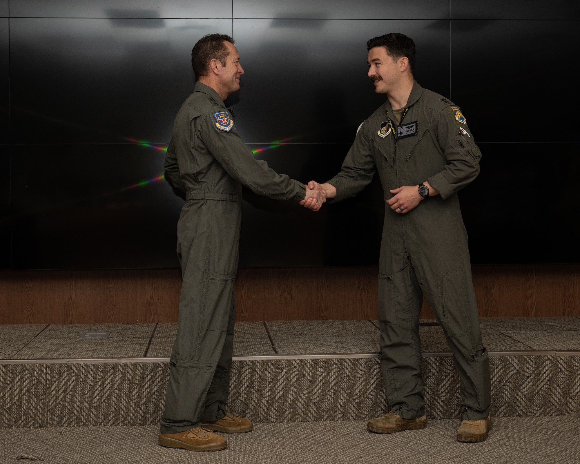 Lt. Gen. David Iverson, left, 7th Air Force commander, coins Capt. Adam Cincione, 8th Fighter Wing plans and program director, at Kunsan Air Base, Republic of Korea.