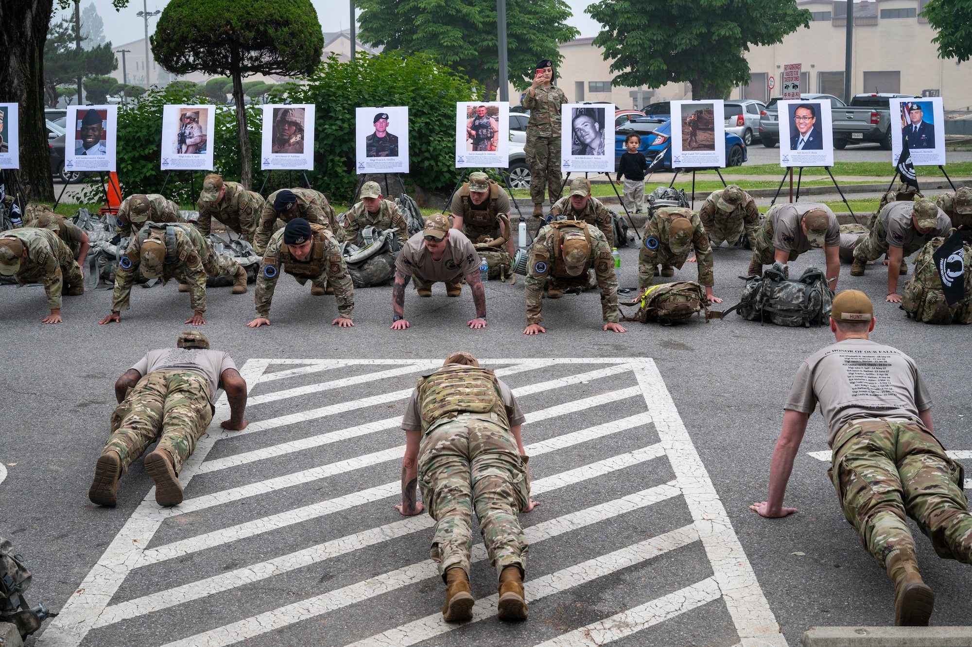U.S. Air Force Airmen assigned to the 51st Fighter Wing perform push-ups for a Fallen Defender 5K Ruck during National Police Week at Osan Air Base, Republic of Korea, May 22, 2024. The push-ups were done in honor of service members who died in the line of duty, with a final push-up in solidarity of their commitment and service to defending freedom. (U.S. Air Force photo by Senior Airman Sabrina Fuller-Judd)