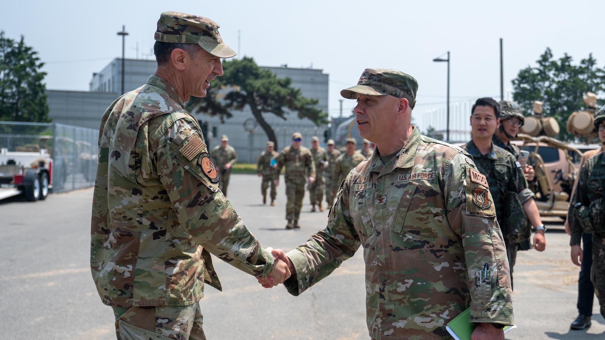 Gen. Kevin Schneider is greeted by Col. Christopher Lacek.