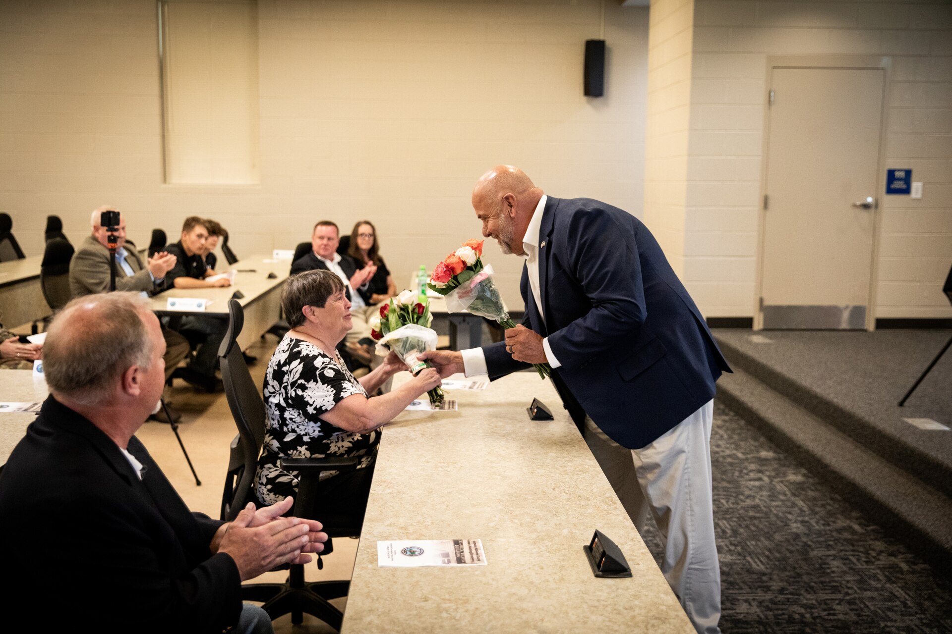 Retired U.S. Army Brig. Gen. Charlie Jones presents flowers to the family of Chief Warrant Officer 5 Joe Wilkins during the building renaming ceremony in remembrance of Wilkins at Wendell H. Ford Regional Training Center (WHFRTC) in Greenville, Kentucky on May 24, 2024. Wilkins was one of the three original full-time employees that helped make WHFRTC a full functioning state training site. (U.S. Army National Guard photo by Andy Dickson)