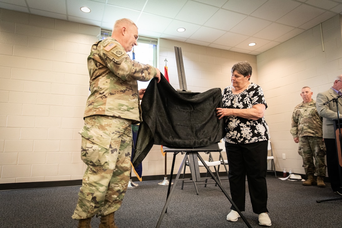 U.S. Army Maj. Gen. Haldane Lamberton, the adjutant general of the Kentucky National Guard, and Frances Wilkins, widow of Chief Warrant Officer 5 Joe Wilkins, unveils the plaque for the building renaming in remembrance of Joe Wilkins at Wendell H. Ford Regional Training Center (WHFRTC) in Greenville, Kentucky on May 24, 2024. Joe Wilkins was one of the three full-time employees who made WHFRTC a major state training site. (U.S. Army National Guard photo by Andy Dickson)