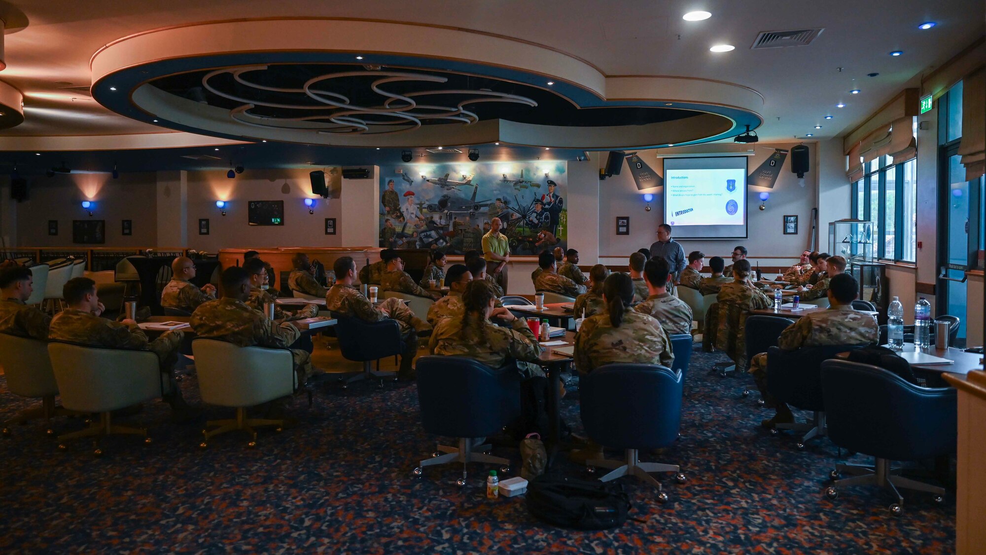 U.S. Airmen assigned to the 100th Air Refueling Wing and 48th Fighter Wing attend a brief about health and safety procedures during exercise Radiant Falcon at Royal Air Force Mildenhall, England, May 23, 2024. The brief prepared Airmen to conduct an aircraft decontamination simulation. Base readiness exercises ensure Airmen are ready to respond to any incident and carry the mission forward. (U.S. Air Force photo by Senior Airman Viviam Chiu)