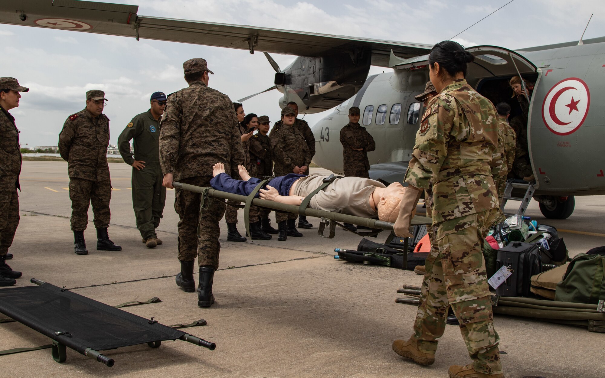 U.S. Air Force Capt. Maria Oliver, a nurse with the 86th Aeromedical Evacuation Squadron based in Ramstein, Germany, works with her Tunisian Armed Forces counterpart to transport a simulated patient onto a Tunisian L-410 Turbolet aircraft during aeromedical evacuation training at exercise African Lion 2024 (AL24) in Tunis, Tunisia, May 2, 2024. AL24 marks the 20th anniversary of U.S. Africa Command’s premier joint exercise led by U.S. Army Southern European Task Force, Africa (SETAF-AF), running from April 19 to May 31 across Ghana, Morocco, Senegal and Tunisia, with over 8,100 participants from 27 nations and NATO contingents. (U.S. Army photo by Maj. Joe Legros)