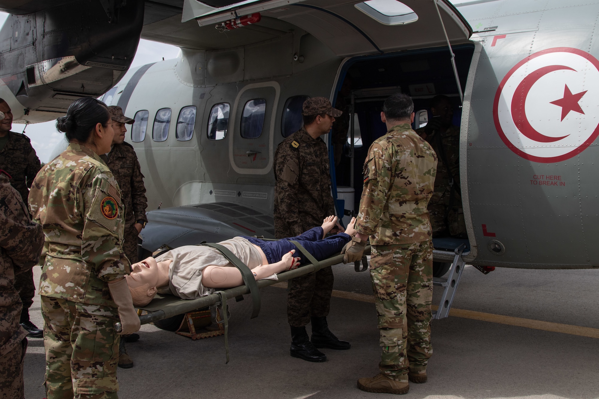 U.S. Air Force Capt. Maria Oliver and Capt. Bob Ostrowski, both nurses with the 86th Aeromedical Evacuation Squadron based in Ramstein, Germany, transport a simulated patient onto a Tunisian L-410 Turbolet aircraft during aeromedical evacuation training at exercise African Lion 2024 (AL24) in Tunis, Tunisia, May 2, 2024. AL24 marks the 20th anniversary of U.S. Africa Command’s premier joint exercise led by U.S. Army Southern European Task Force, Africa (SETAF-AF), running from April 19 to May 31 across Ghana, Morocco, Senegal and Tunisia, with over 8,100 participants from 27 nations and NATO contingents. (U.S. Army photo by Maj. Joe Legros)