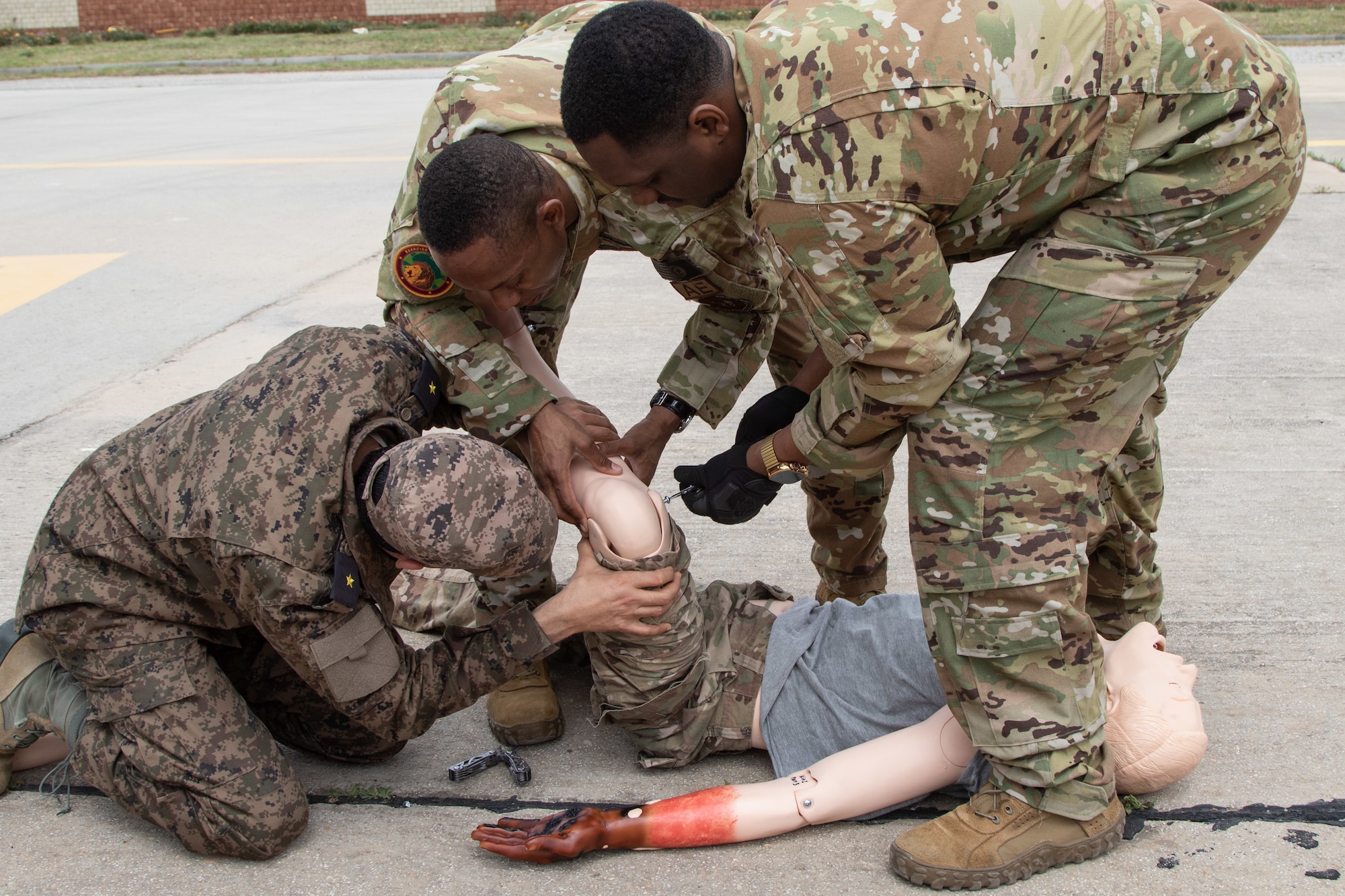 U.S. Air Force Staff Sgt. Devin Bruner, right, works with fellow Staff Sgt. Charles Hayward, both with the 86th Aeromedical Evacuation Squadron based in Ramstein, Germany, and their Tunisian Armed Forces counterpart to prepare a simulated casualty during aeromedical evacuation training at exercise African Lion 2024 (AL24) in Tunis, Tunisia, May 2, 2024. AL24 marks the 20th anniversary of U.S. Africa Command’s premier joint exercise led by U.S. Army Southern European Task Force, Africa (SETAF-AF), running from April 19 to May 31 across Ghana, Morocco, Senegal and Tunisia, with over 8,100 participants from 27 nations and NATO contingents. (U.S. Army photo by Maj. Joe Legros)