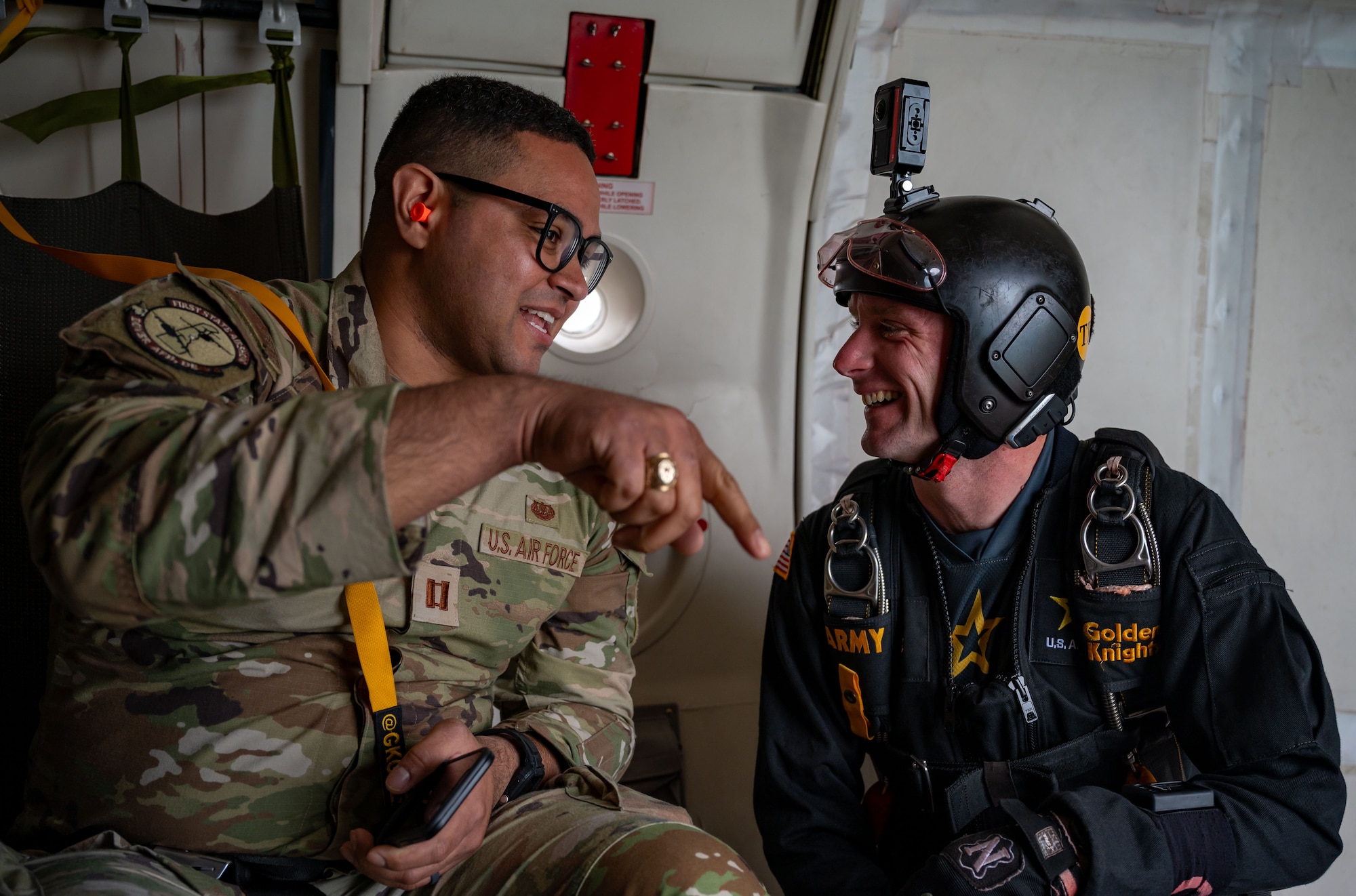 U.S. Air Force Capt. Michael Rivera, 436th Airlift Wing assistant staff judge advocate, speaks with a member of the United States Army Parachute Team, The Golden Knights during the 2024 First State Airshow at Dover Air Force Base, Delaware, May 19, 2024. The First State Airshow was a free, two-day event open to the public that featured 23 static displays and 18 aerial performers. (U.S. Air Force photo by Amanda Jett)
