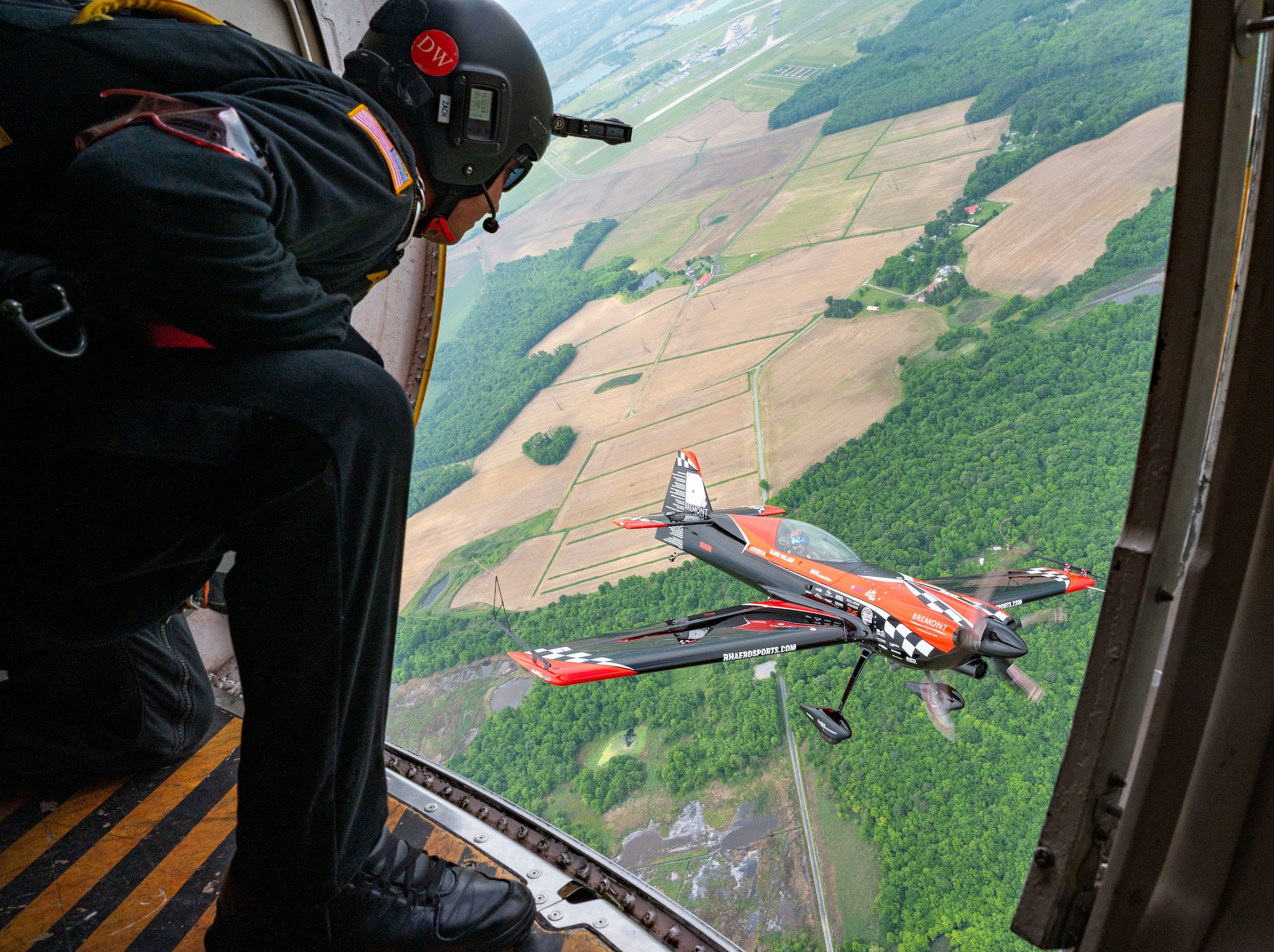 Members of the United States Army Parachute Team, The Golden Knights fly in formation alongside of Rob Holland, aerial demostration pilot, in his MXS-RH during 2024 First State Airshow at Dover Air Force Base, Delaware, May 17, 2024. The Golden Knights were one of 18 performers at the First State Airshow. (U.S. Air Force photo by Senior Airman Amanda Jett)