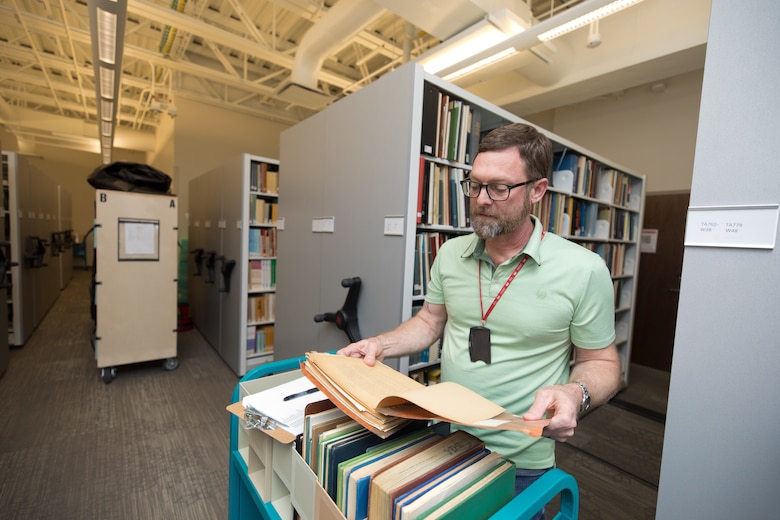 Adam frost stands in the ERDC library.