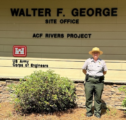 Park Ranger standing in front of a building.