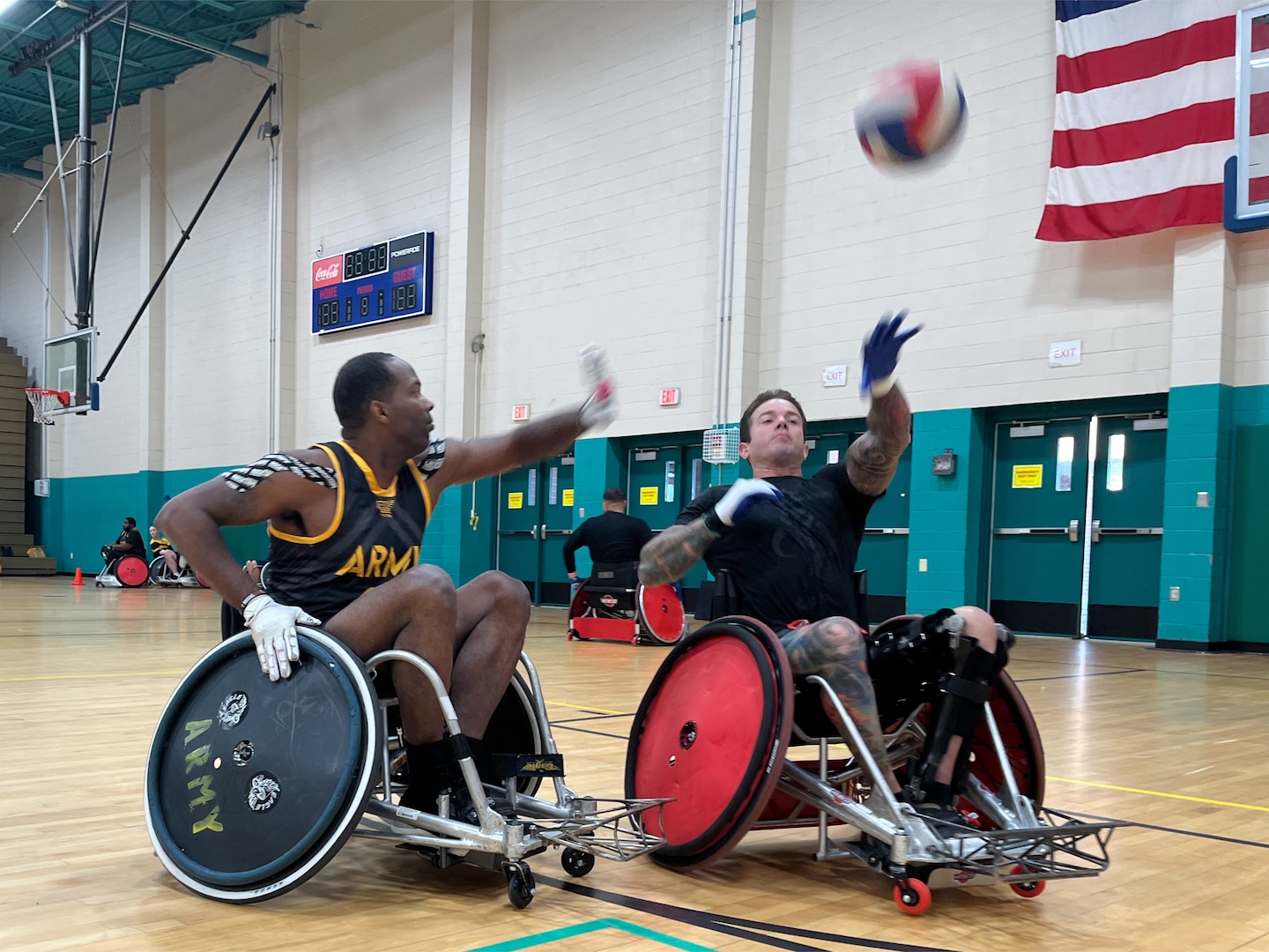 Master Sgt. Micheal Haley makes a pass while Staff Sgt. Derrick Thompson goes for a block during wheelchair rugby practice May 23 at Fort Stewart’s Newman Fitness Center. Eighteen rugby athletes, part of a 40-Soldier team, practiced at Fort Stewart before competing for the Army in the DoD Warrior Games June 21-30 in Orlando, Florida. Winn Army Community Hospital’s Soldier Recovery Unit sponsored the Army team for an Army Sports Team Camp, part of the Army Recovery Care Program. The weeklong camp ended May 24 and included practices for other adaptive team sports as well as learning sessions about mobility, nutrition and sports psychology.