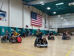 Retired Spc. Michael Villagran reaches for a pass as his teammates look on during wheelchair rugby practice May 23 at Fort Stewart’s Newman Fitness Center. Eighteen rugby athletes, part of a 40-Soldier team, practiced at Fort Stewart before competing for the Army in the DoD Warrior Games June 21-30 in Orlando, Florida. Winn Army Community Hospital’s Soldier Recovery Unit sponsored the Army team for an Army Sports Team Camp, part of the Army Recovery Care Program. The weeklong camp ended May 24 and included practices for other adaptive team sports as well as learning sessions about mobility, nutrition and sports psychology.