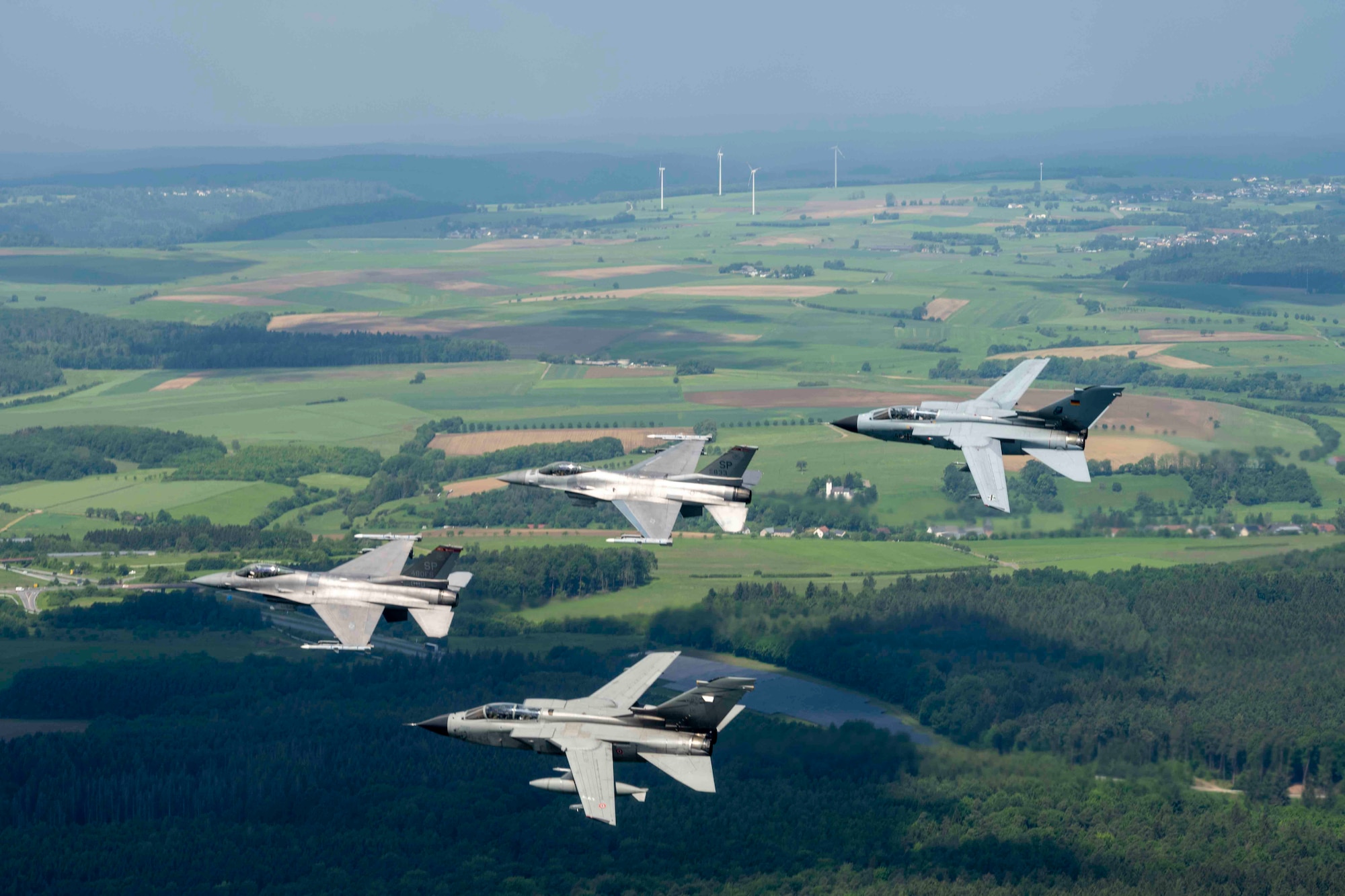 U.S. Air Force F-16 Fighting Falcon fighter aircraft and German and Italian Air Force Tornado fighter aircrafts fly in formation to celebrate the 50-year anniversary of the F-16 and Tornado aircraft models at Spangdahlem Air Base, Germany, May 23, 2024.