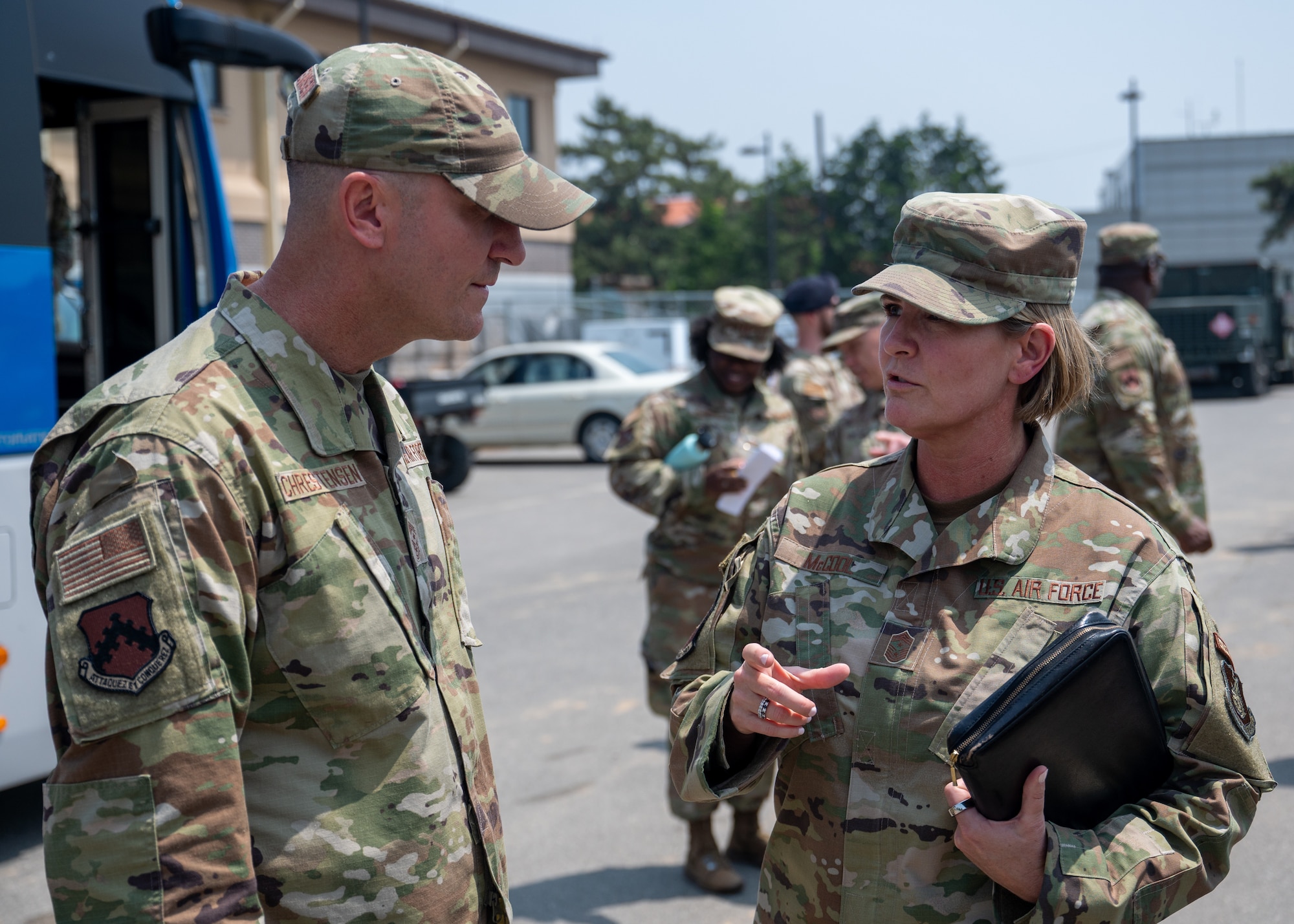 Chief Master Sgt. Kathleen McCool speaks with Chief Master Sgt. Nathan Chrestensen.