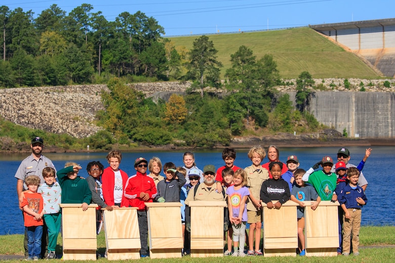 Park rangers and volunteers from the U.S. Army Corps of Engineers, Savannah District, J. Strom Thurmond Lake and Dam, pause for a photo with Cub Scout Pack 45, from Augusta, Georgia, during a National Public Lands Day event at Thurmond Dam and Lake, Clarks Hill, South Carolina, Sept. 23, 2023. The Cub Scouts assembled bat boxes to be installed at lake campgrounds to attract bat species for insect control and to provide alternative roosting sites for conservation.