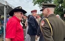 A veteran shares a laugh with Capt. Joshua Box, aide-de-camp, after the Memorial Day event in downtown Augusta, Ga.