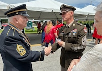 Command Sgt. Maj. Michael Starrett speaks to a veteran sergeant major after the Memorial Day ceremony in downtown Augusta, Ga.
