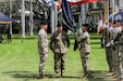 From left to right, Command Sgt. Maj. Scott A. Brzak, outgoing U.S. Army Pacific command sergeant major; Gen. Charles A. Flynn, USARPAC command general; and Command Sgt. Maj. Jason Schmidt, incoming USARPAC command sergeant major, awaits the passing of the colors during USARPAC's change of responsibility ceremony May 23, 2024.