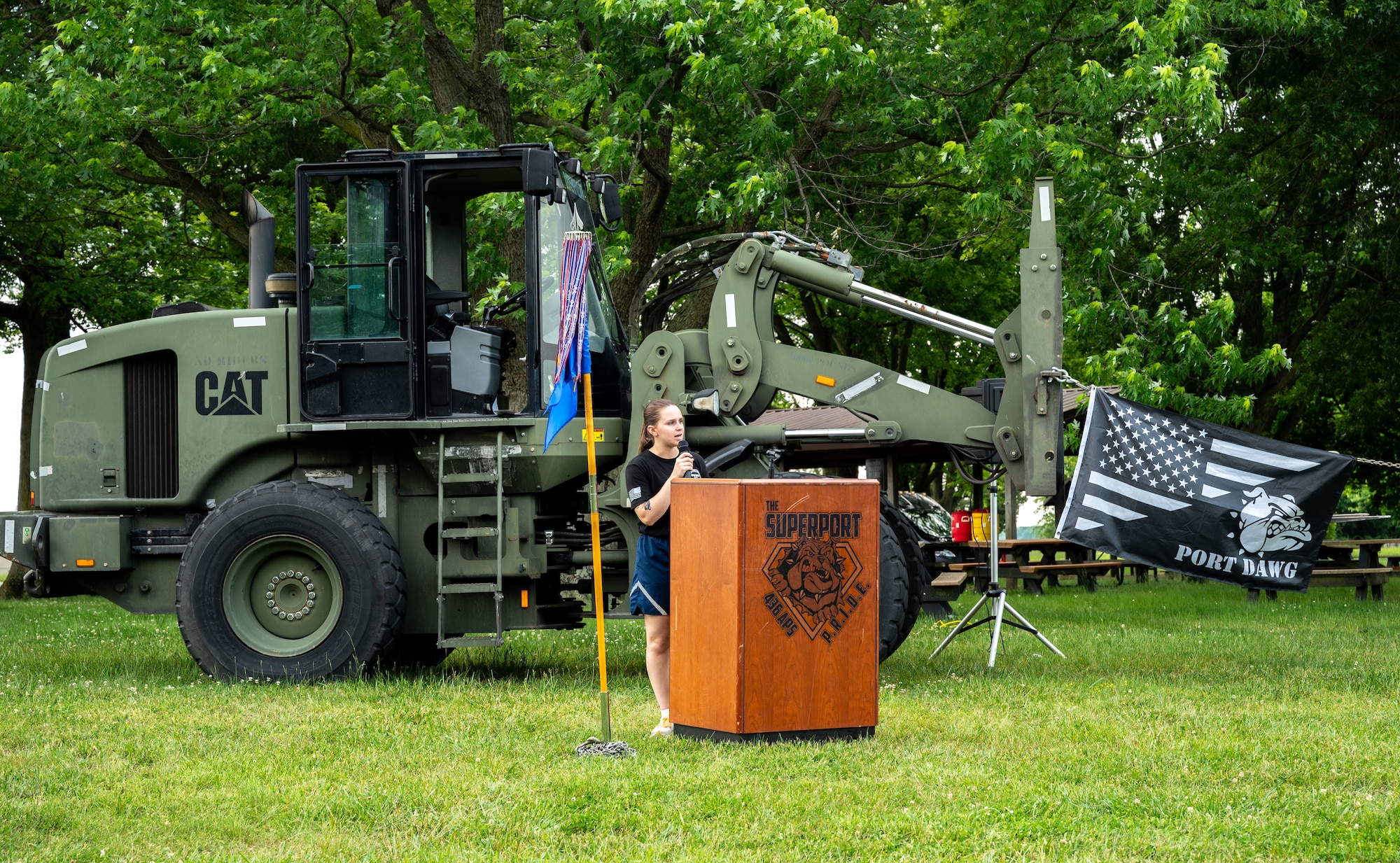 U.S. Air Force Staff Sgt. Cecelia Bak, 436th Aerial Port Squadron passenger service supervisor, gives opening remarks during the annual Port Dawg Memorial Run at Dover Air Force Base, Delaware, May 23, 2024. The 2.2-mile run is held each year in honor of fallen members from aerial ports across the country. (U.S. Air Force photo by Senior Airman Amanda Jett)