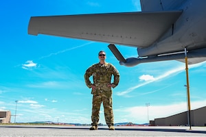 Airman standing next to plane