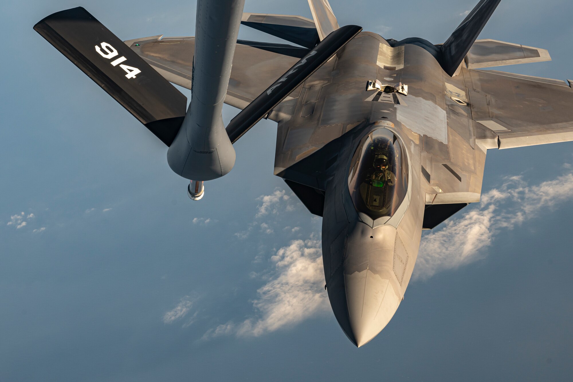 A U.S. Air Force F-22 Raptor receives fuel from an Air Force KC-135 Stratotanker during exercise Checkered Flag.