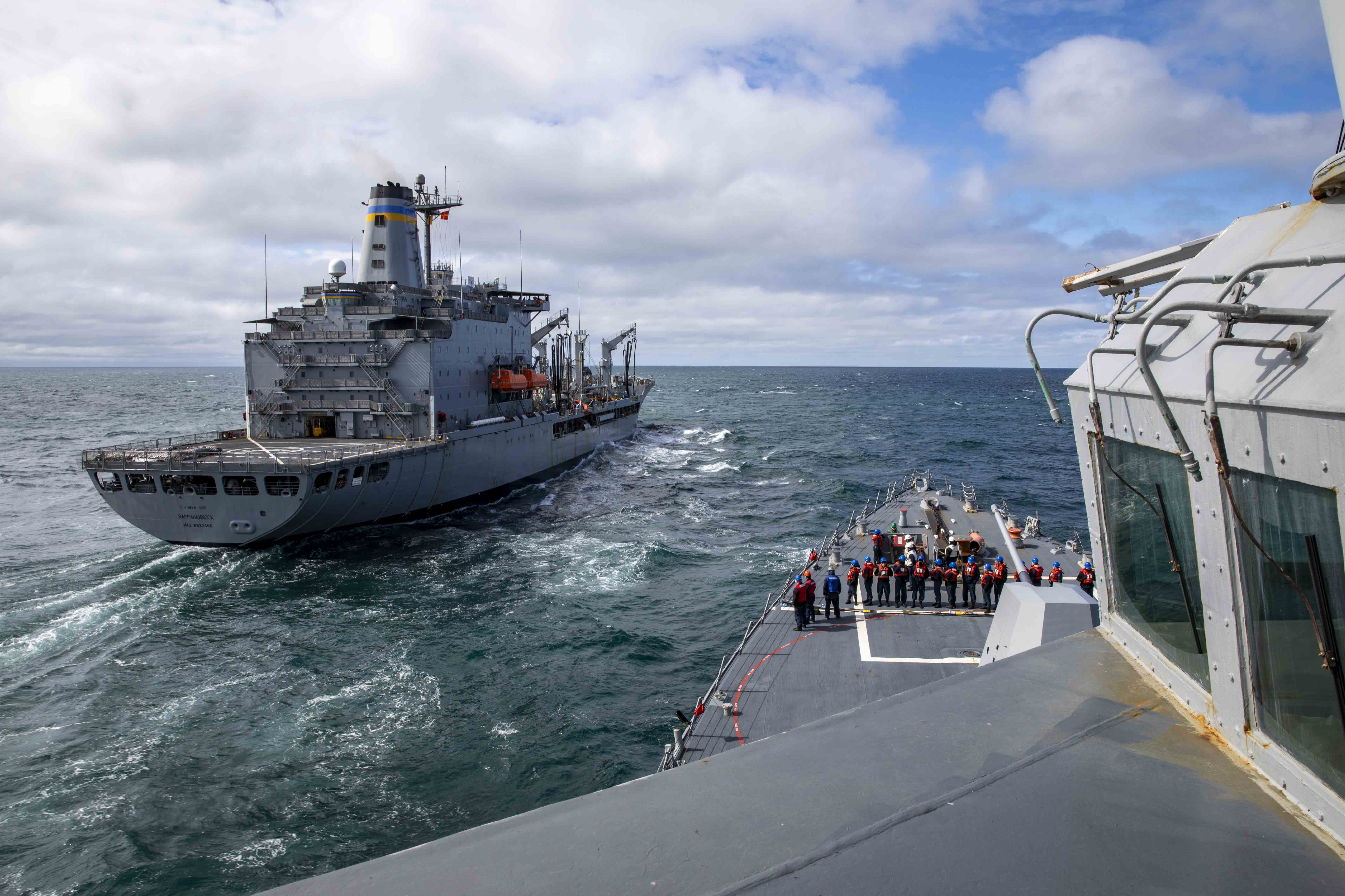 The Arleigh Burke-class guided-missile destroyer USS Ralph Johnson (DDG 114) conducts a replenishment-at-sea with USNS Rappahannock (T-AO-204)