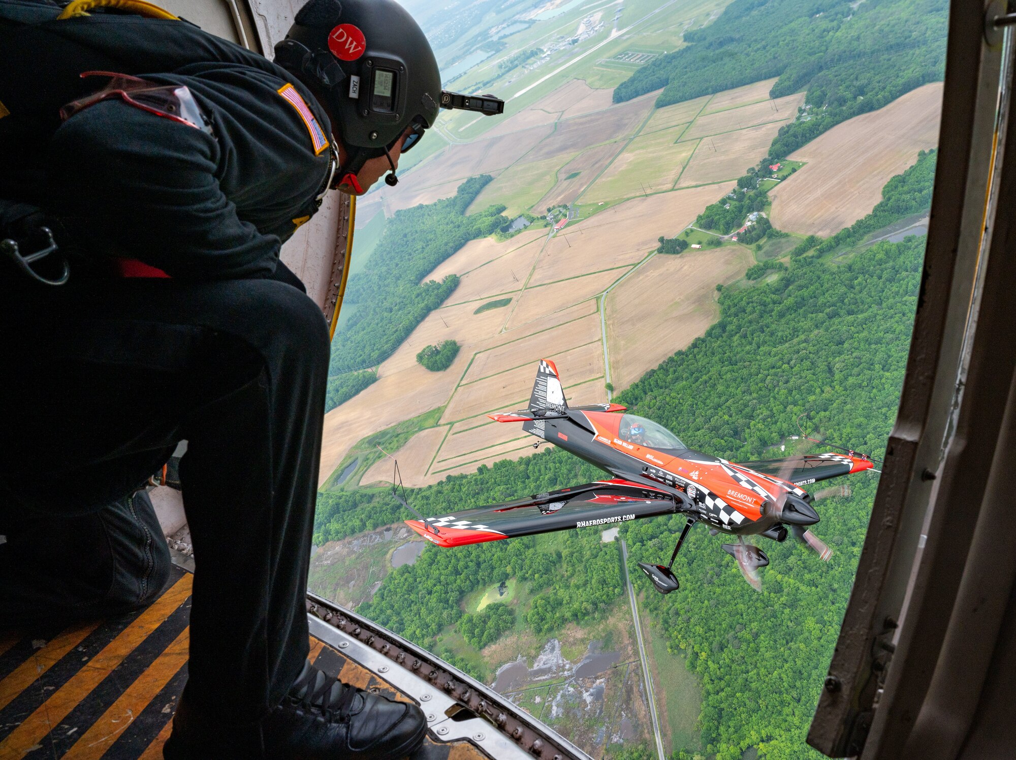 Members of the United States Army Parachute Team, The Golden Knights fly in formation alongside of Rob Holland, aerial demostration pilot, in his MXS-RH during 2024 First State Airshow at Dover Air Force Base, Delaware, May 17, 2024. The Golden Knights were one of 18 performers at the First State Airshow. (U.S. Air Force photo by Senior Airman Amanda Jett)