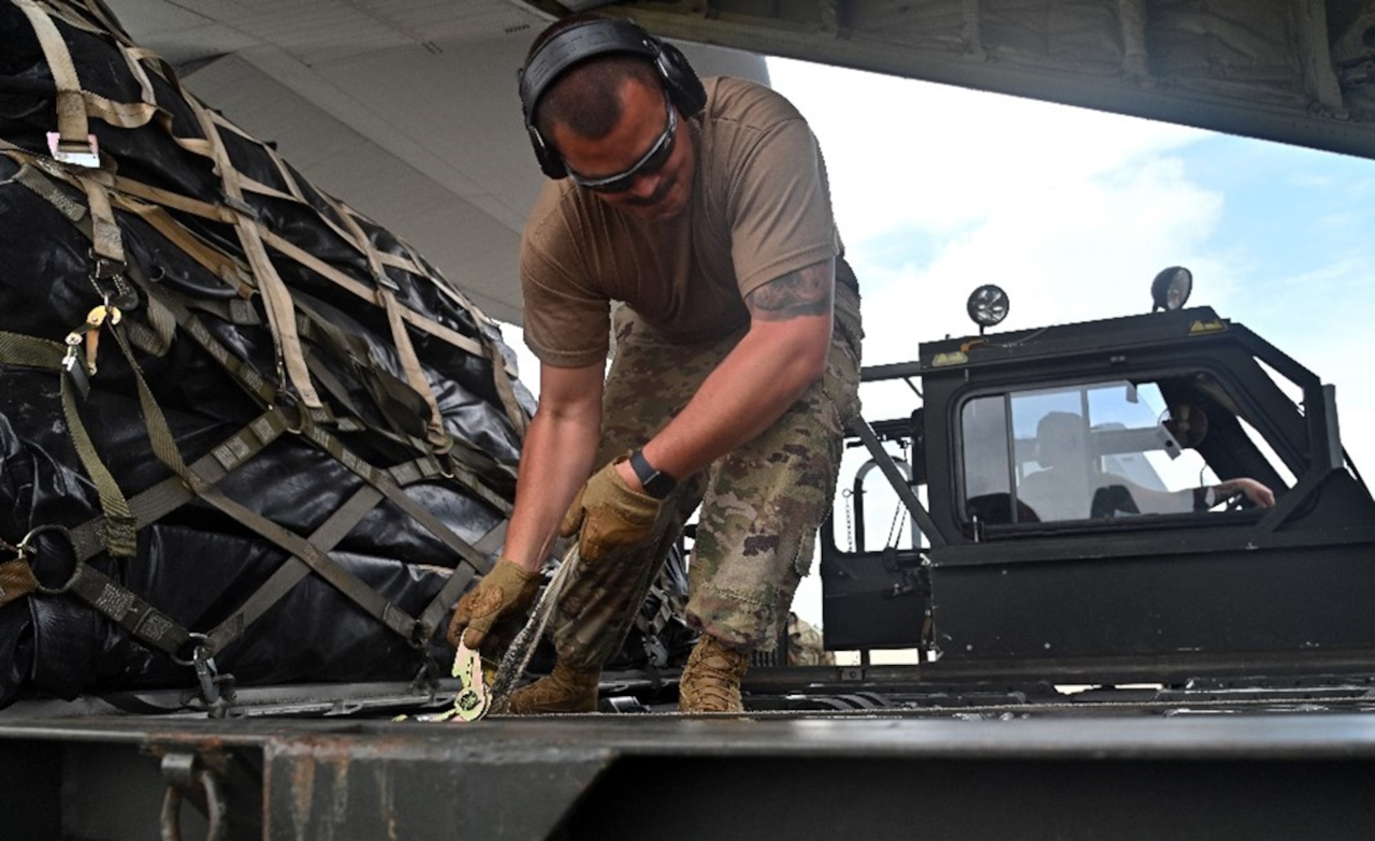 U.S. Air Force Tech. Sgt. Jeff Treadway, 521st Contingency Response Squadron aerial porter, secures cargo during Exercise Storm Flag in Alexandria, La., May 5, 2024. The exercise aimed to support the U.S. Army’s 10th Mountain Division deployment certification and scheme of maneuver.