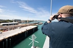 Machinist’s Mate Nuclear 2nd Class Donald Westbrook, assigned to the submarine tender USS Emory S. Land (AS 39), watches as the tender arrives at HMAS Coonawarra, Darwin, Northern Territory, Australia, for a regularly scheduled port call, May 28.