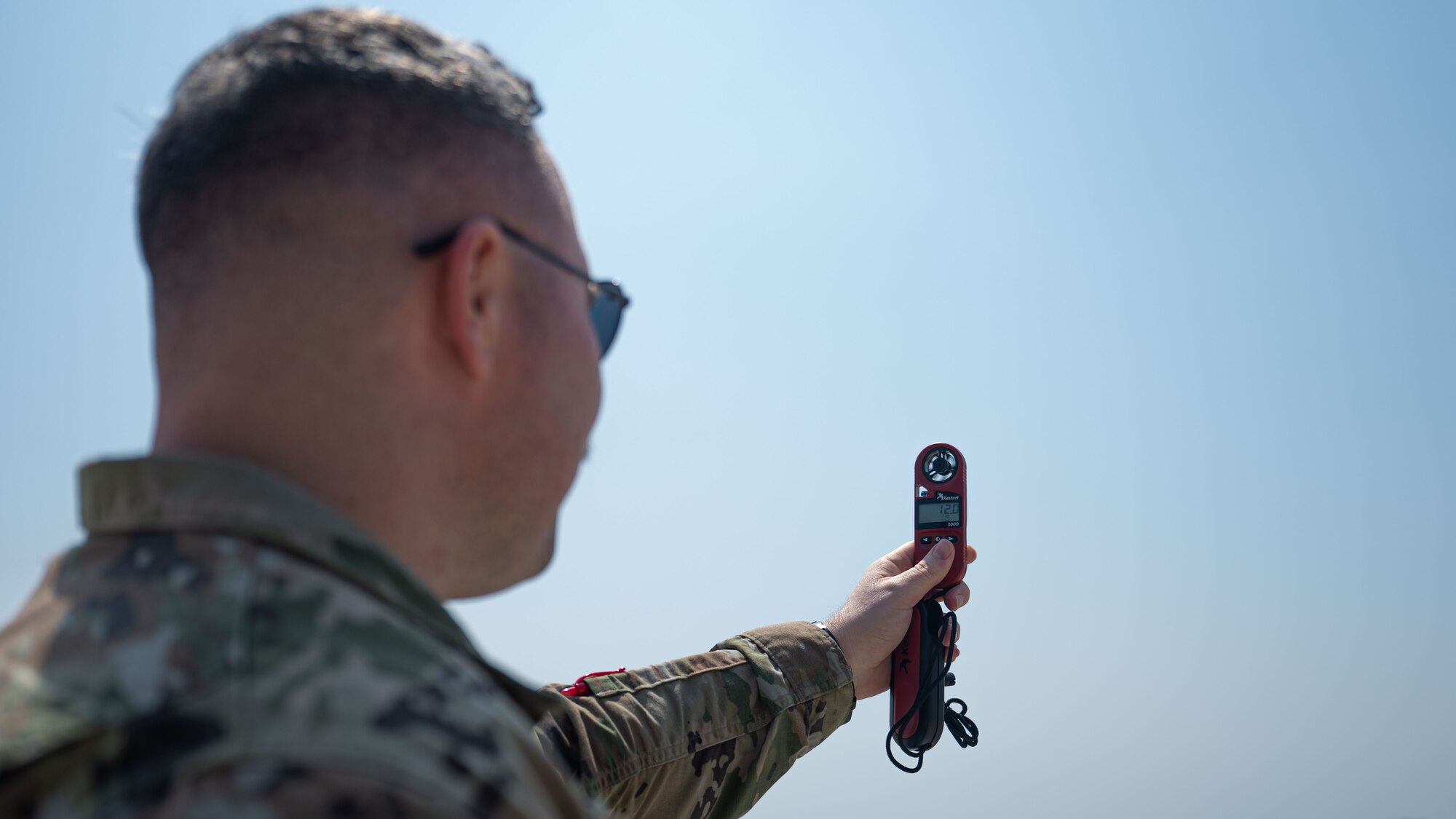 Tech. Sgt. Austin Young, 8th Operations Support Squadron non-commissioned officer in charge of airfield weather operations, utilizes a kestrel to collect weather information.