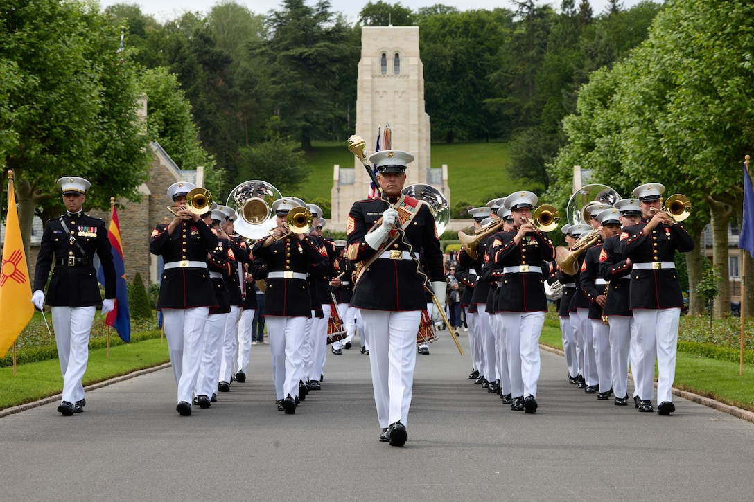 The 2nd Marine Division Band marches out to conclude the 2024 Belleau Wood Ceremony at the Aisne-Marne American Cemetery and Memorial, France, May 26, 2024. The memorial ceremony was held in commemoration of the 106th anniversary of the battle of Belleau Wood, conducted to honor the legacy of service members who gave their lives in defense of the United States and European allies. (U.S. Marine Corps photo by Lance Cpl. Garrett Gillespie)
