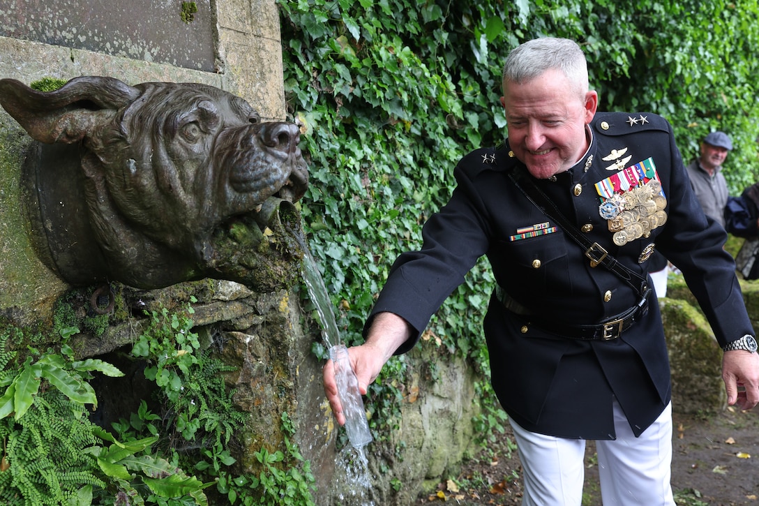 U.S. Marine Corps Maj. Gen. Robert B. Sofge Jr., commander of U.S. Marine Corps Forces Europe and Africa, gathers a souvenir from Devil Dog Fountain in Belleau Wood, France, May 26, 2024. The memorial ceremony was held in commemoration of the 106th anniversary of the battle of Belleau Wood, conducted to honor the legacy of service members who gave their lives in defense of the United States and European allies. (U.S. Marine Corps photo by Lance Cpl. Garrett Gillespie)