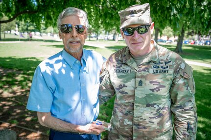 U.S. Army Command Sgt. Maj. Arthur Fredericks, the Connecticut National Guard's senior enlisted advisor, presents Rick Maynard a Connecticut World War I Campaign Medal in honor of his great-uncle's service with the 102nd Infantry Regiment in World War I. Sgt. Paul Maynard served with Company M in multiple battles across France and ultimately perished on the last day of the War.