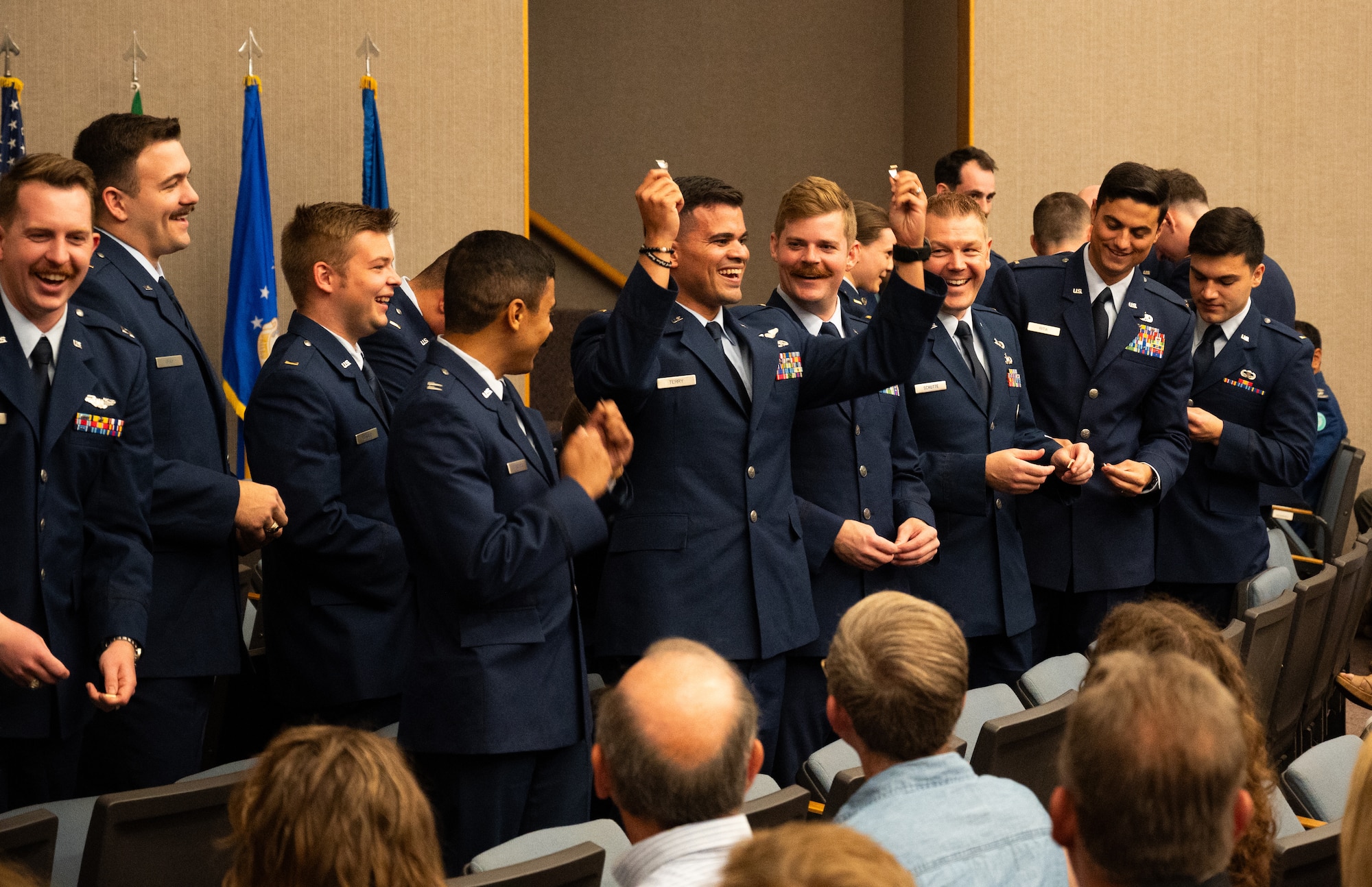 U.S. Air Force Airmen from graduating Class 24-10 break their wings at Laughlin Air Force Base, Texas, May 23, 2024. Twenty-seven U.S. Air Force officers were awarded silver wings during the ceremony, symbolizing their completion of the Undergraduate Pilot Training program. (U.S. Air Force photo by Airman Harrison Sullivan)