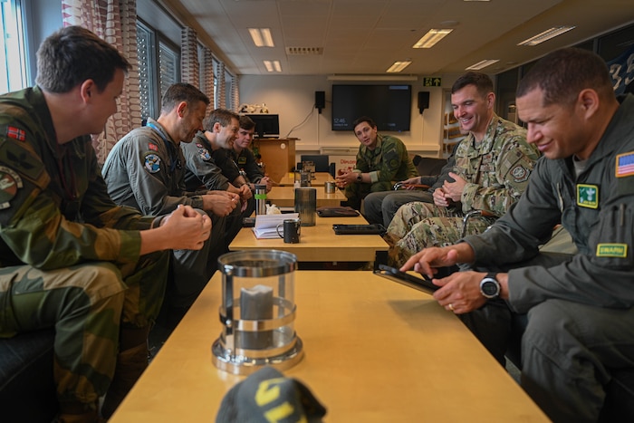 U.S. Air Force Airmen assigned to the 61st Airlift Squadron debrief with Royal Norwegian Air Force Airmen assigned to the 335th Squadron at Station Group Gardermoen, Norway, May 13, 2024. Collaboration is at the core of the C-130J's mission. Designed with interoperability in mind, it seamlessly integrates with Allied forces, facilitating joint operations and enhancing military cooperation.