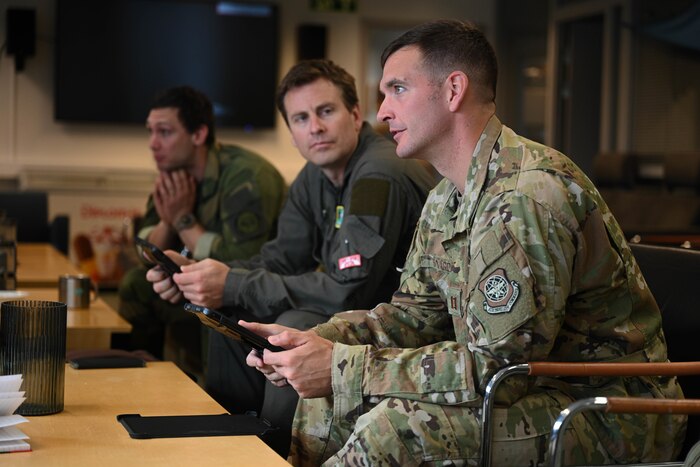 U.S. Air Force Capt. Scott Sivard, 61st Airlift Squadron pilot, discusses with Royal Norwegian Air Force Airmen assigned to the 335th Squadron at Station Group Gardermoen, Norway, May 9, 2024. Collaboration is at the core of the C-130J's mission. Designed with interoperability in mind, it seamlessly integrates with Allied forces, facilitating joint operations and enhancing military cooperation.