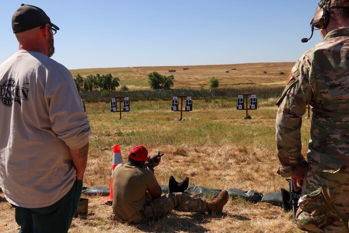 U.S. Air Force Senior Airman Johnathan Gibbs, 9th Security Forces combat arms and maintenance (CATM) instructor demonstrates one of the positions to fire rifles during a rifle Excellence-in-Competition with the M4 Carbine at Beale AFB, Calif., May 15, 2024.