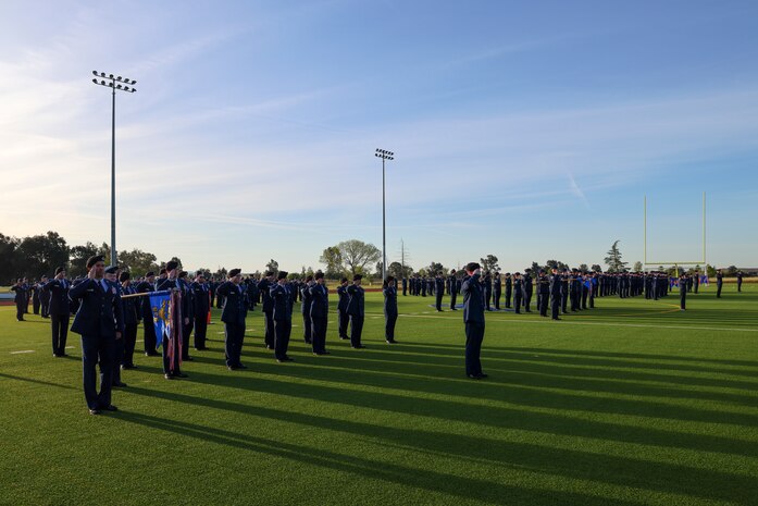 The 9th Mission Support Group salutes for reveille during an open ranks inspection at Beale Air Force Base, California, April 10, 2024.