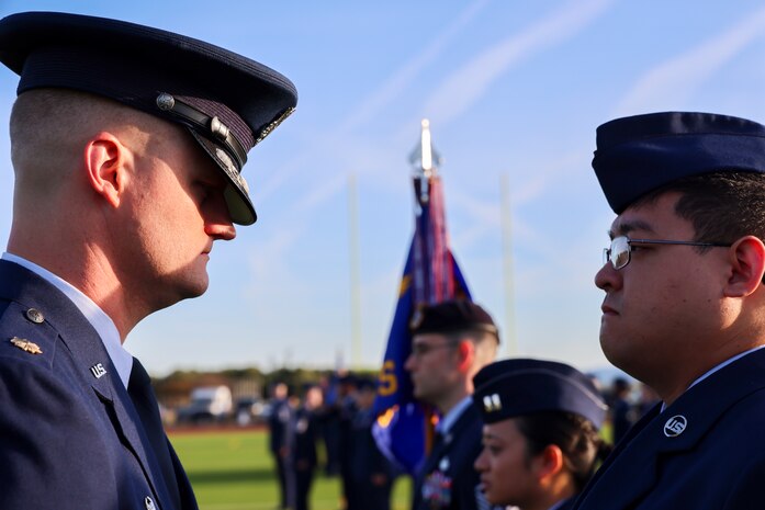 U.S. Air Force Maj. Joshua Larson, 9th Communications Squadron commander, inspects Staff Sgt. Kim, during the 9th Mission Support Group open ranks inspection at Beale Air Force Base, California, April 10, 2024.