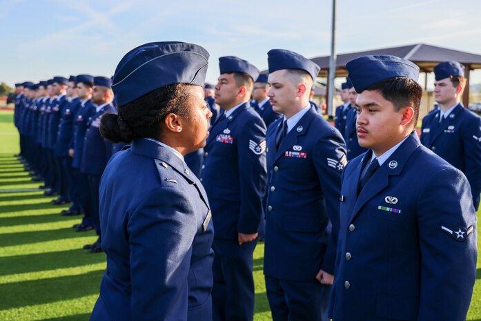 U.S. Air Force 1st Lt. Andi Brown, 9th Civil Engineer Squadron readiness and emergency management flight commander, inspects members of the 9th CES during the 9th Mission Support Group open ranks inspection at Beale Air Force Base, California, April 10, 2024.