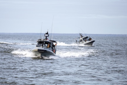 Two security patrol boats navigate in a river in Annapolis, Maryland.