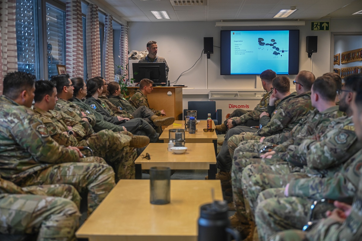 Royal Norwegian Air Force Maj. Pål-Christian Grosvold, 335th Squadron pilot, welcomes U.S. Air Force members assigned to the 61st Airlift Squadron to Norway at Station Group Gardermoen, Norway, May 9, 2024. Training with joint service members, Allies and partners increases lethality and enhances interoperability, allowing forces to counter military aggression and coercion by sharing responsibilities for common defense.
