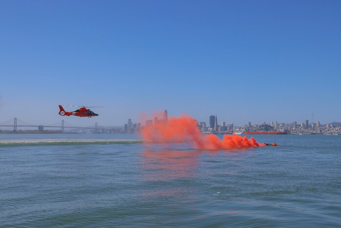 Members of Beale Air Force Base signal to U.S. Coast Guard San Francisco Sector Search and Rescue (SAR) team for evacuation from San Francisco Bay, California, April 30, 2024.