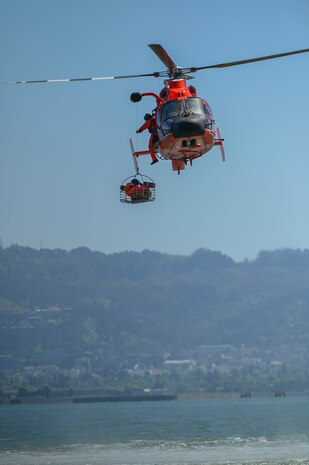 U.S. Air Force 9th Reconnaissance Wing U-2 Dragon Lady pilot is lifted in the rescue basket by the U.S. Coast Guard San Francisco Sector rescue team aboard the MH-65 Dolphin in San Francisco Bay, California, April 30, 2024.