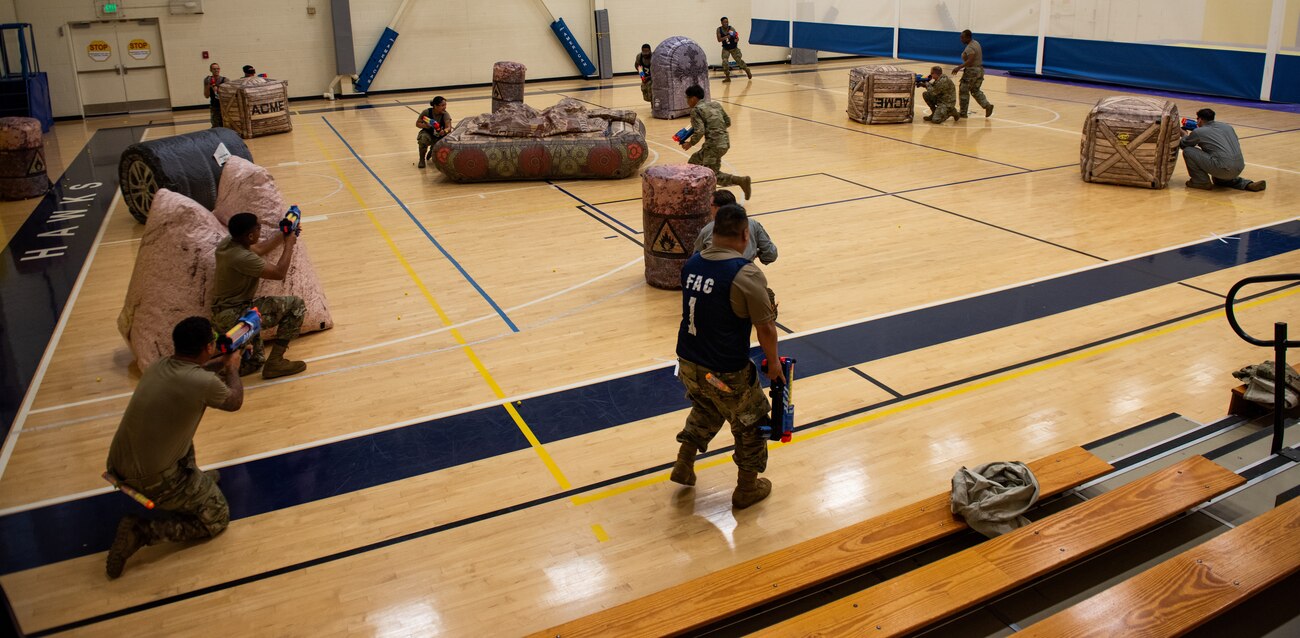 Airmen take cover during a nerf game