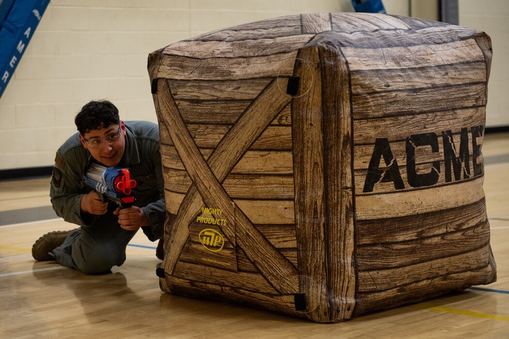 Airman taking cover during a nerf game