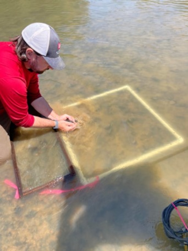 ERDC researcher David Ruppel performing a quadrate survey for Big Black Rocksnails