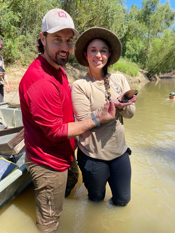 ERDC researchers David Ruppel with a Big Black Rocksnail and Ashley Ruppel with a Butterfly mussel
