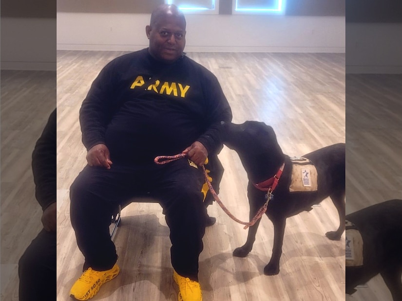 Staff Sgt Todd Summers with a service dog