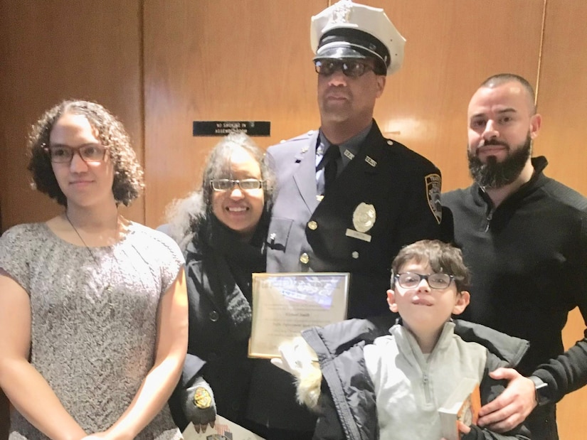 NYPD Officer Michael Smith and his children and grandson.